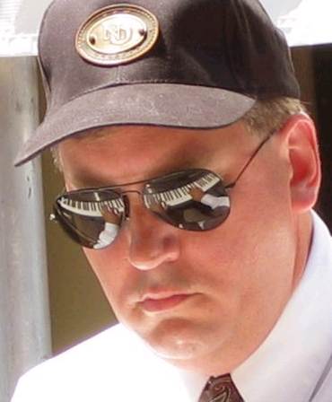 John Royen wearing sunglasses at the piano